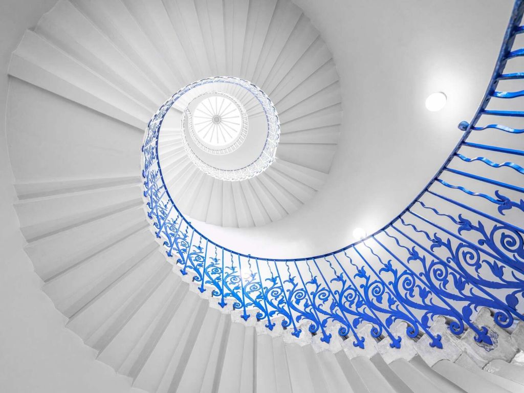Weiße Wendeltreppe mit blauem Geländer